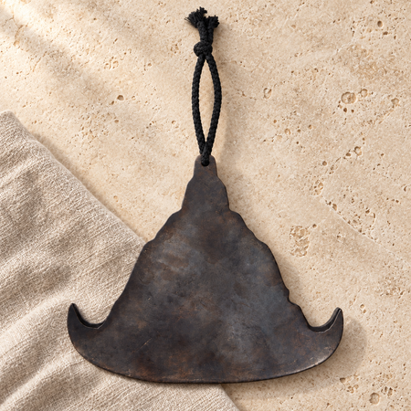 Gong in metallo con cordino nero, still life su pietra chiara e lino naturale